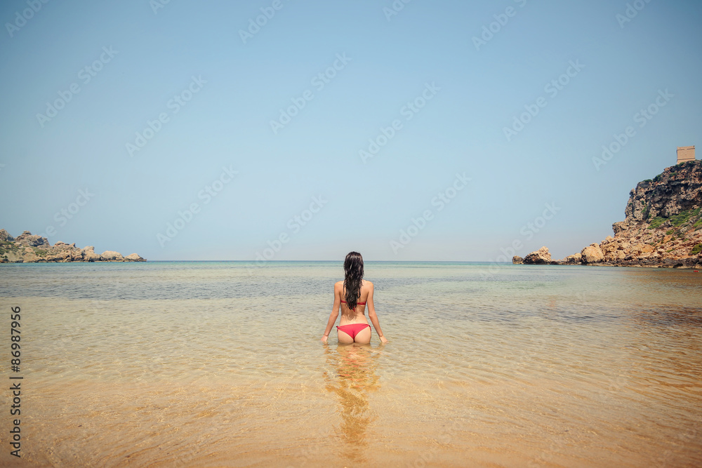 Woman standing in the water at the beach