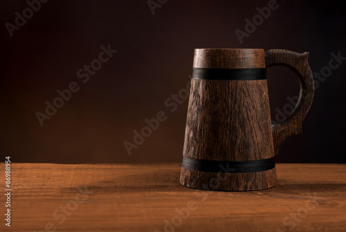 Mug of fresh beer on a wooden table.