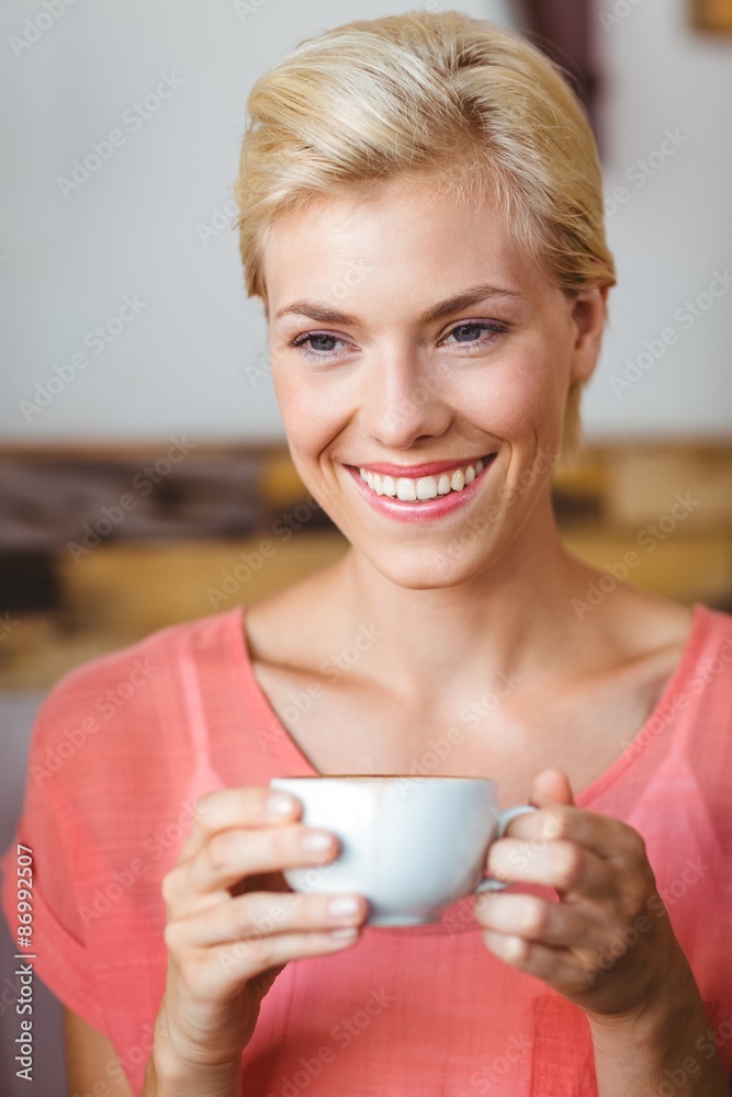 Pretty blonde woman holding a cup of coffee Pretty blonde woman holding a cup of coffee