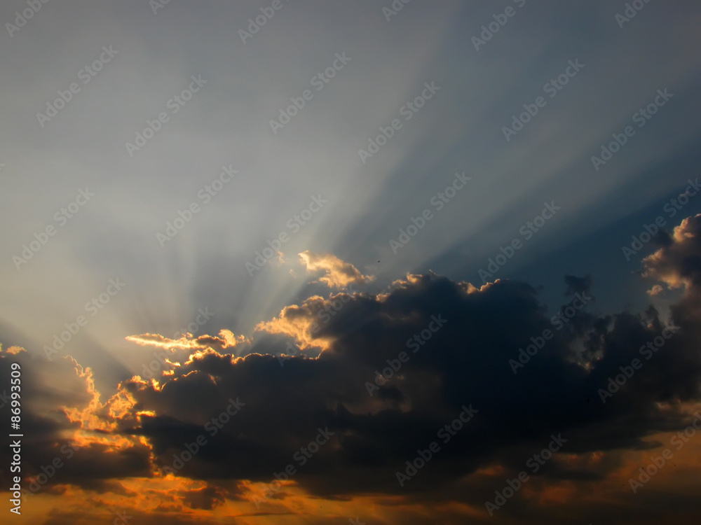 Dramatic sun rays through the clouds -  crepuscular rays 