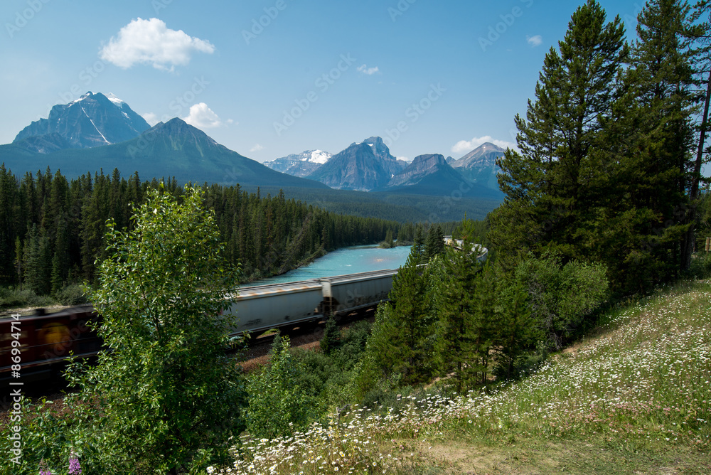 A train going thru a beautiful mountain in Canada A train going thru a beautiful mountain in Canada