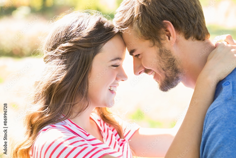 Cute coupe smiling at each other in park Cute coupe smiling at each other in park