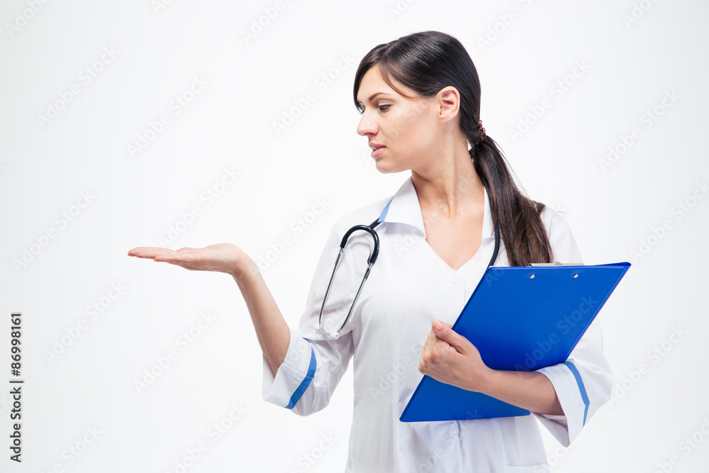 Doctor with clipboard holding copyspace on her palm Doctor with clipboard holding copyspace on her palm