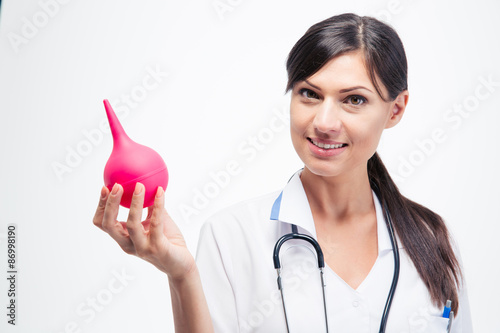 Obraz na plátne Happy female doctor holding enema
