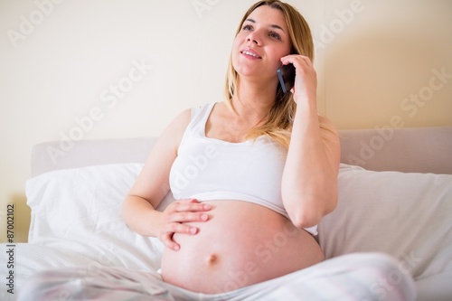 Pregnant woman having phone call 