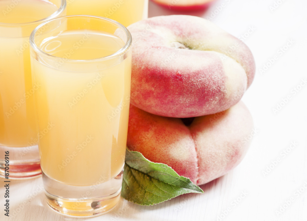 Fresh peach juice with fruits on a white wooden background, sele Fresh peach juice with fruits on a white wooden background, sele