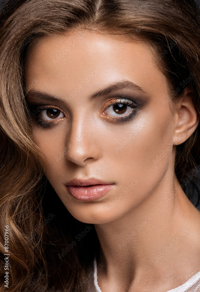 young woman with long glossy curly hairstyle young woman with long glossy curly hairstyle