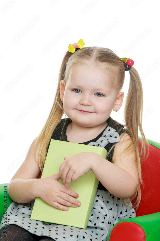 Portrait of little blond with a long ponytail that sits on the c Portrait of little blond with a long ponytail that sits on the c