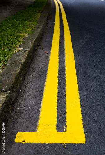 start of double yellow lines curving round bend