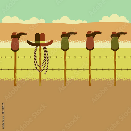 Cowboy boots on fence post