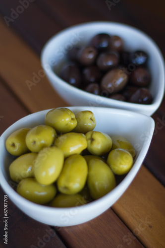 Green and black olives in ceramic pots