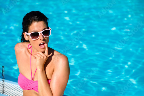 Surprised woman on summer vacation at swimming pool © Dirima