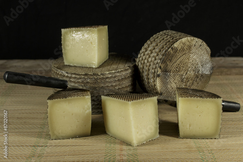 Sheep milk cheeses with double-handled knife