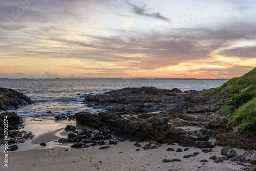 Sunset on rocky beach at Salvador city, Bahia
