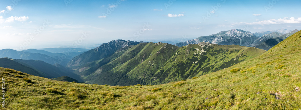 Fototapeta premium Panorama of amazing summer mountains under blue sky