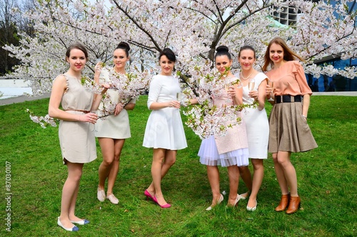 Girls with champagne celebrating in sakura's garden.