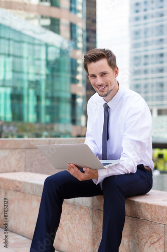 Canvas Print Caucasian young businessman use of the notebook computer