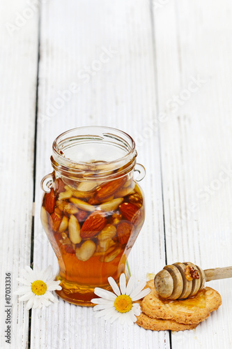 Honey in glass jars with flowers