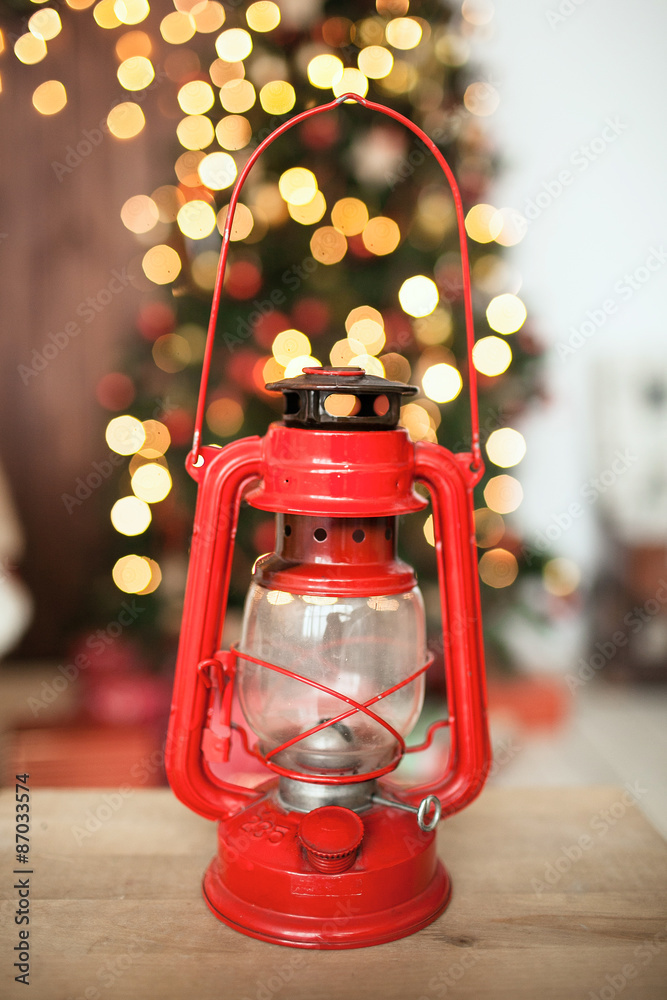 Red vintage oil lamp in front of Christmas tree