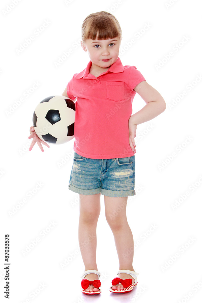 Adorable little blonde girl in denim shorts and red shirt is Adorable little blonde girl in denim shorts and red shirt is