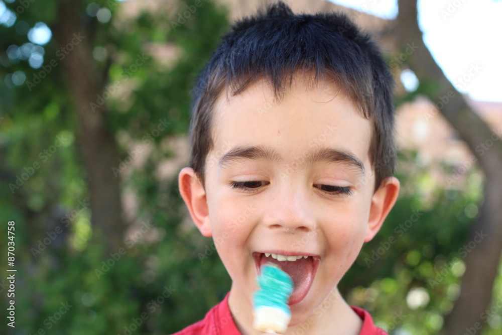 Beautiful little boy holding a yummy candy Beautiful little boy holding a yummy candy