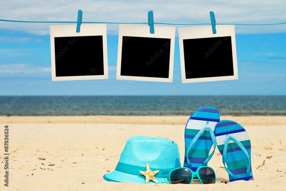 blank instant photos hanging on clothesline at the beach
