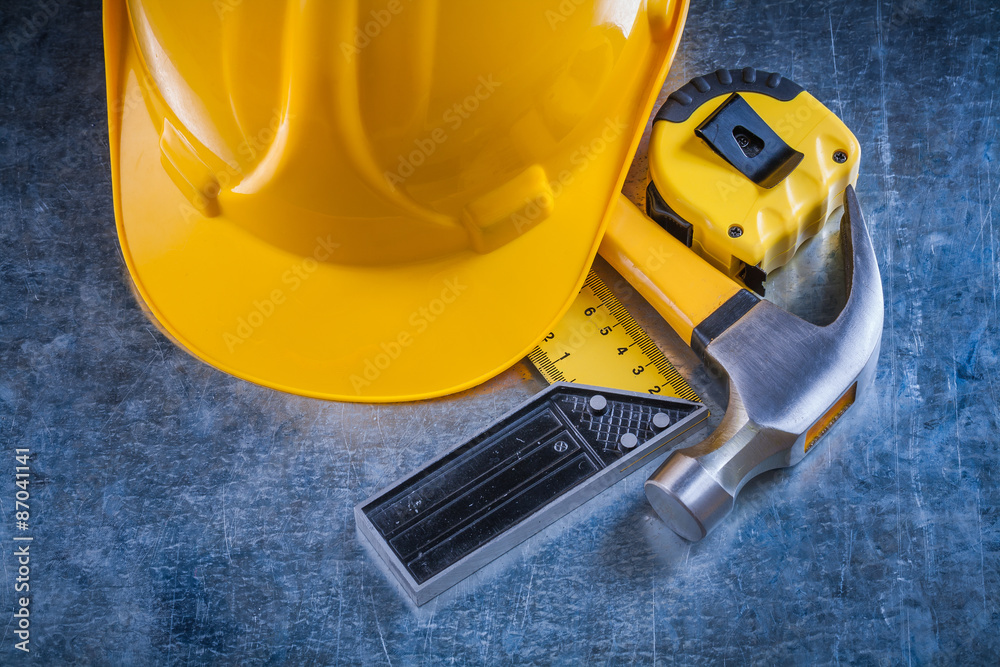 Square ruler measuring tape building helmet and claw hammer on s Square ruler measuring tape building helmet and claw hammer on s