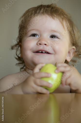 Portrait of small baby boy with apple