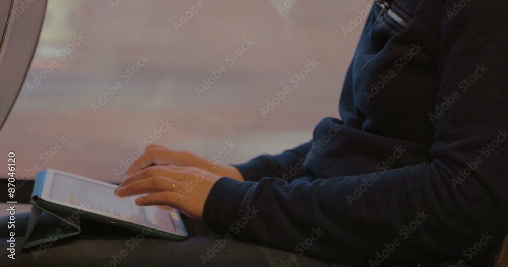 Woman Writing on Tablet PC during the Trip Woman Writing on Tablet PC during the Trip