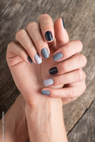 Beautiful hands with the miniature painted in a gray-colored nai