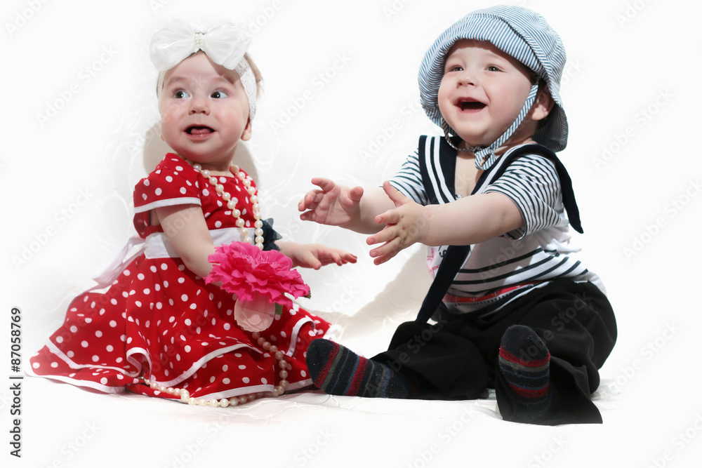 little girl in a red dress and a boy little girl in a red dress and a boy