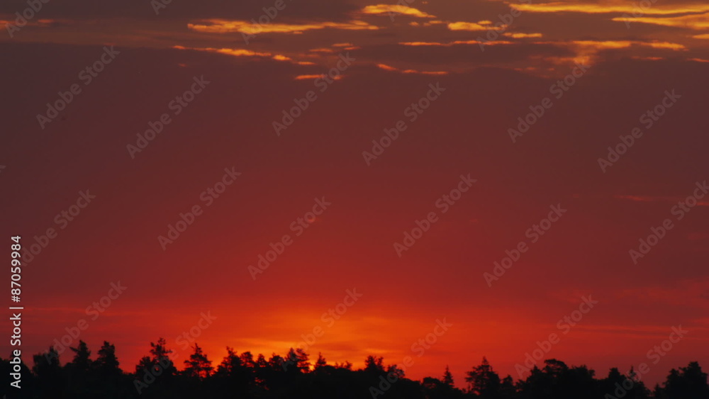 Time lapse shot of the morning sunrise through the clouds
