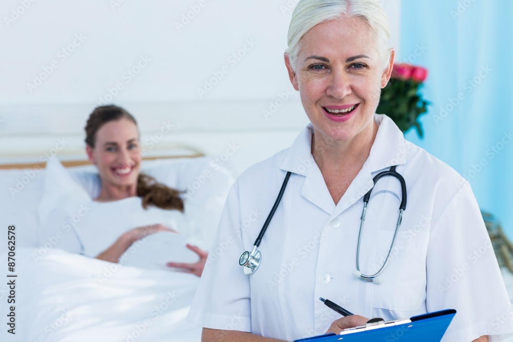 Female doctor and pregnant woman smiling at camera Female doctor and pregnant woman smiling at camera