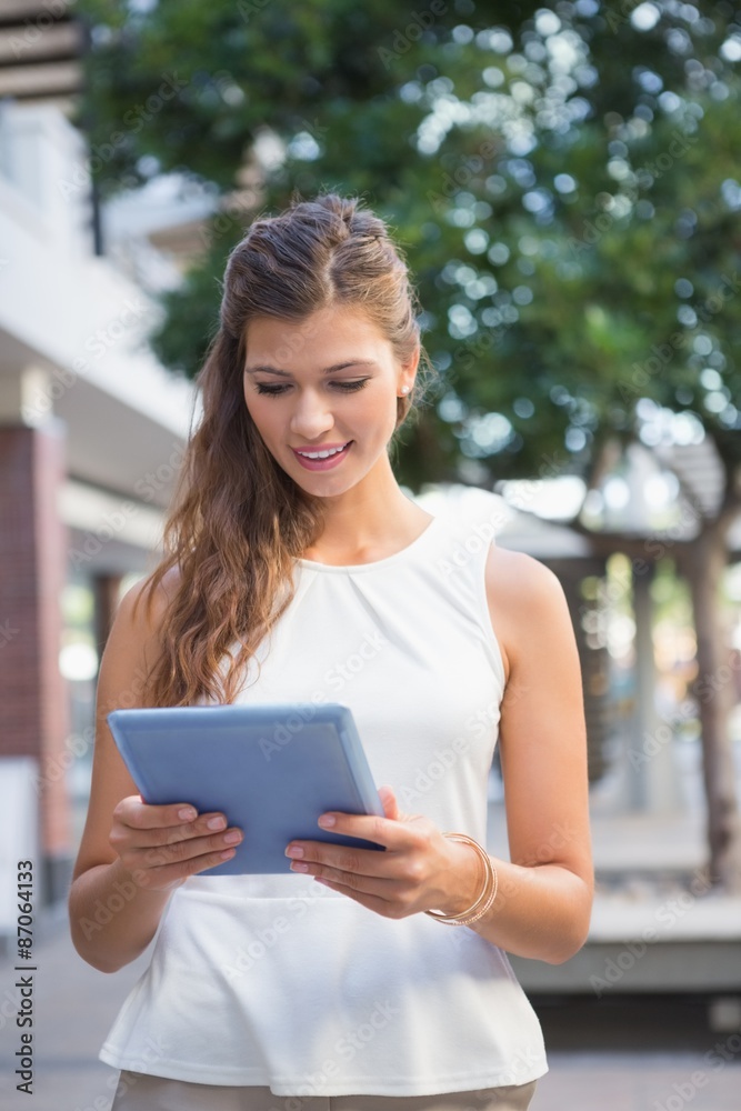 Smiling woman using tablet computer Smiling woman using tablet computer