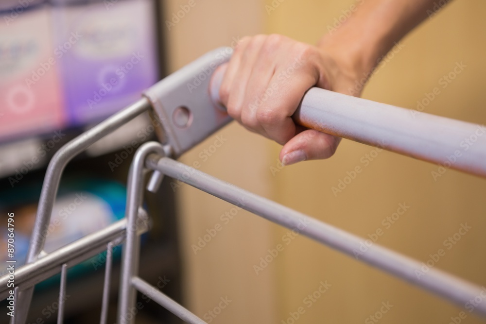 Hand of woman putting on trolley
