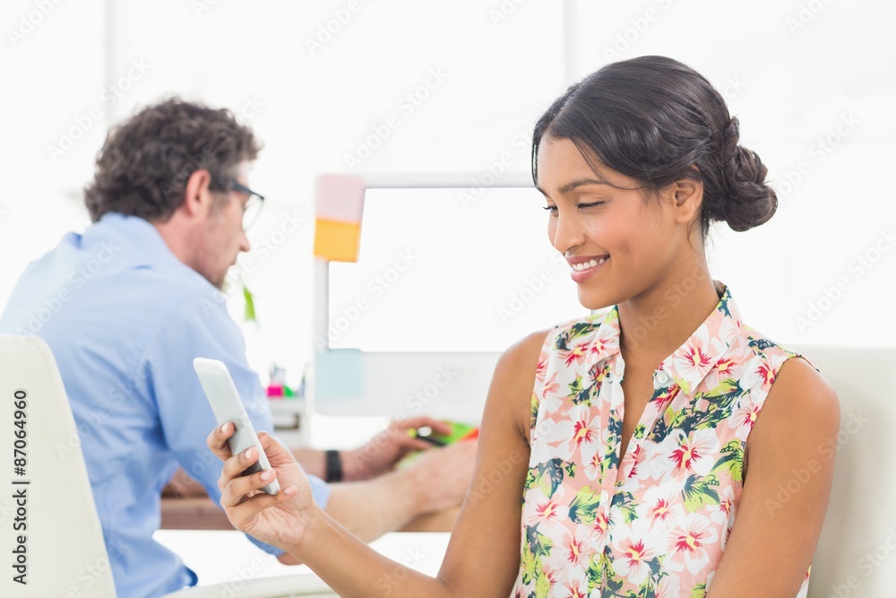 Businesswoman standing and using smartphone Businesswoman standing and using smartphone