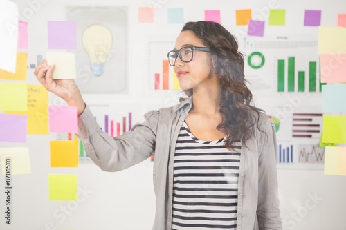  Pretty designer looking at post its on window