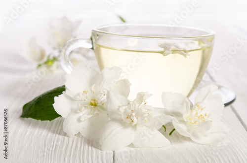 Glass cup of tea with jasmine on the white background