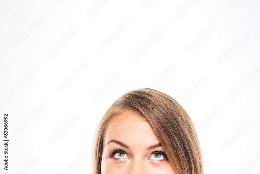 Cropped image of a young woman looking up Cropped image of a young woman looking up