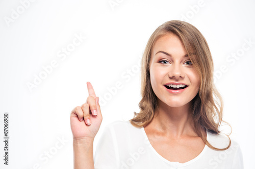 Woman pointing finger up and looking at camera
