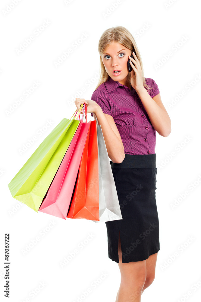 Woman holding shopping bags and talking on phone