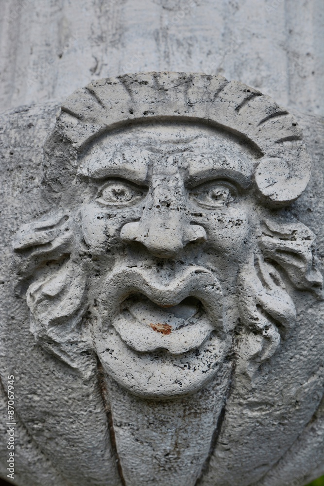 Ugly stone face sculpture