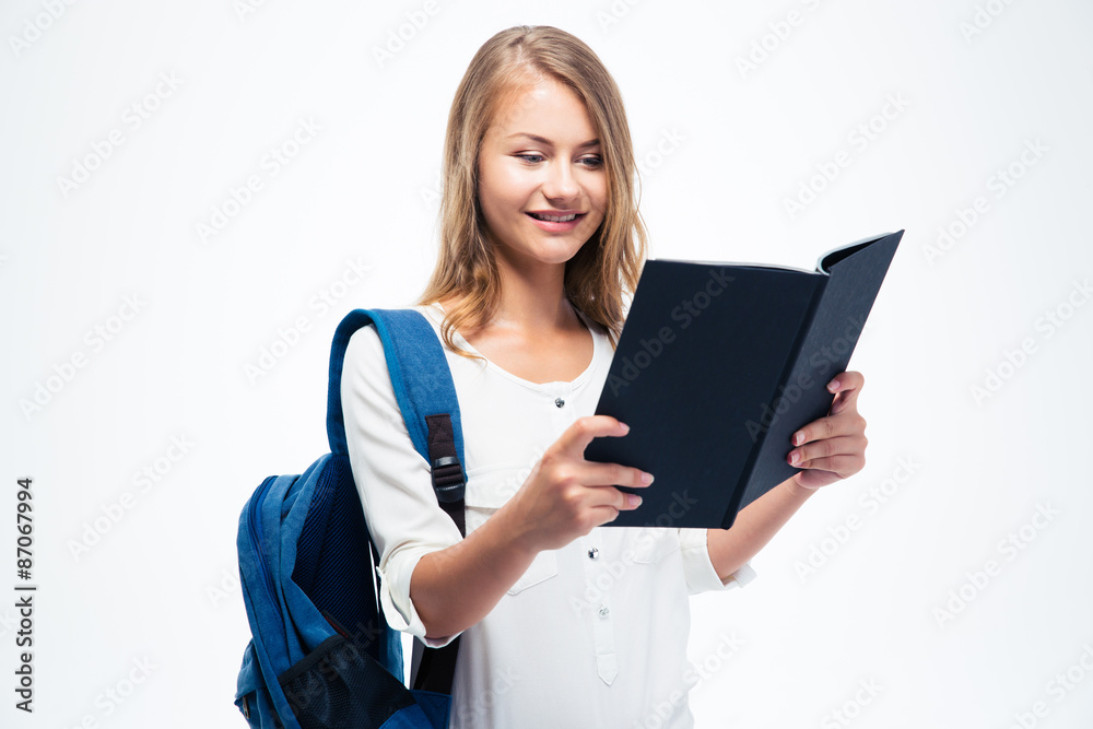Smiling girl with backpack reading book Smiling girl with backpack reading book