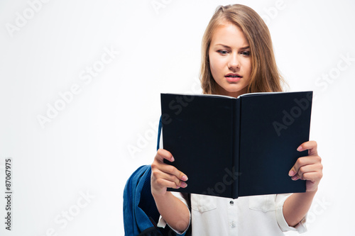 Girl with backpack reading book