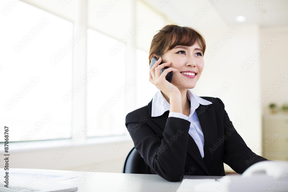 businesswoman talking on the phone in the office businesswoman talking on the phone in the office