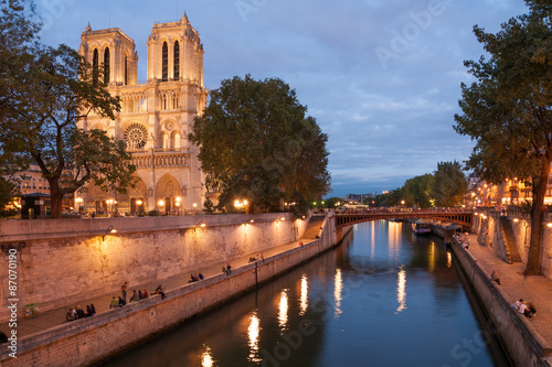 Notre Dame de Paris and Seine embankment in summer evening