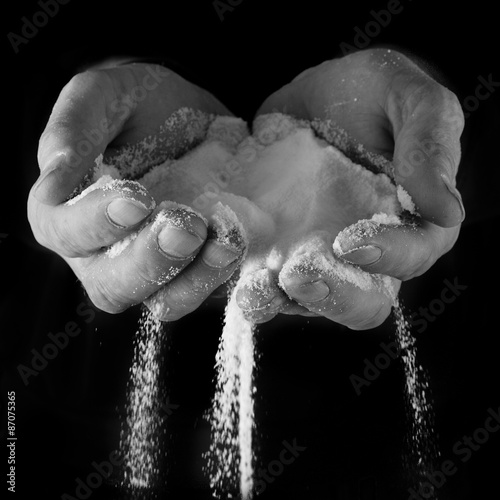 Male hands with salt pouring through