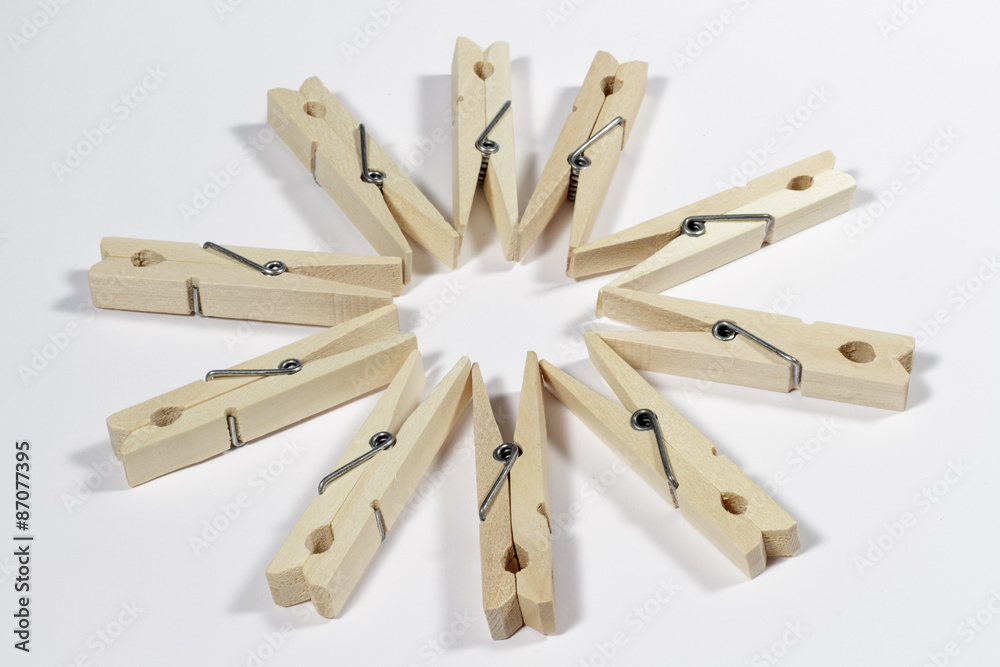 Clothespins placed to form a ten-pointed star in the center, on a white background Clothespins placed to form a ten-pointed star in the center, on a white background