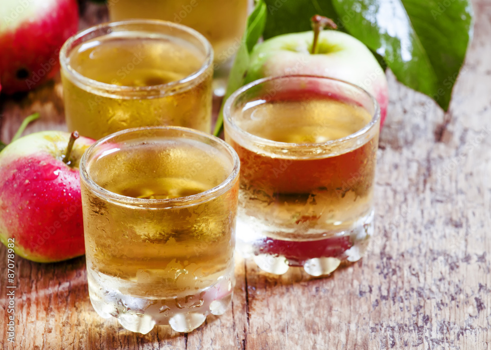 Cold apple juice and fresh apples on an old wooden table, select Cold apple juice and fresh apples on an old wooden table, select