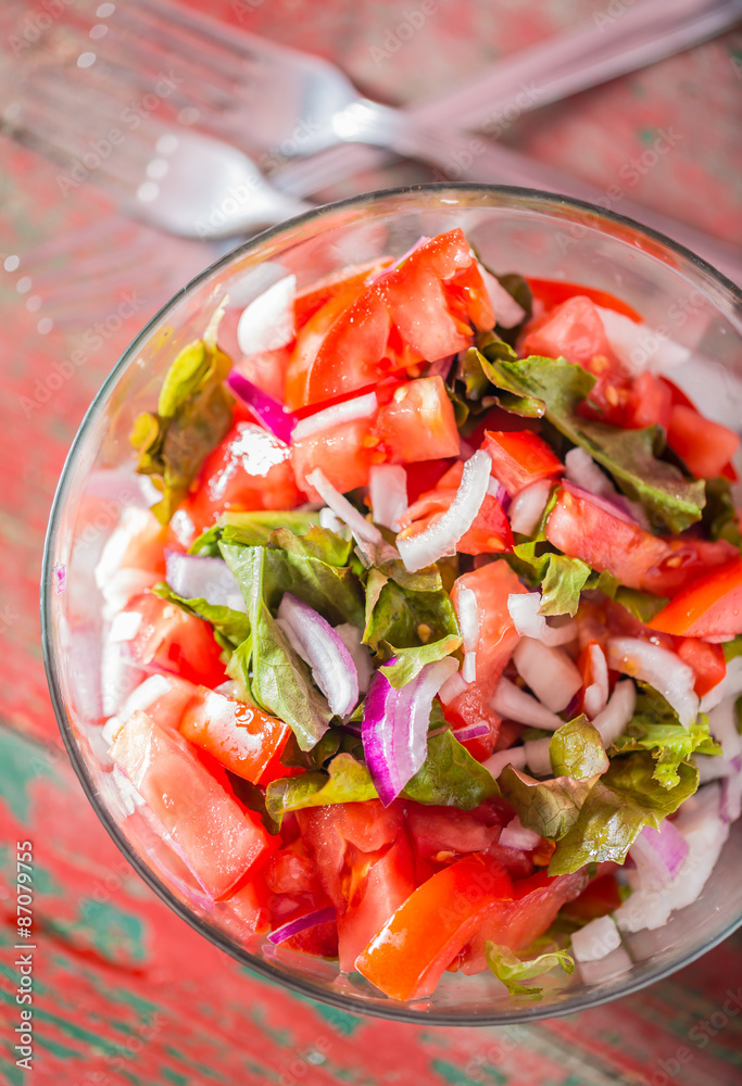 Fresh tomatoes with onion and lettuce in bowl Fresh tomatoes with onion and lettuce in bowl